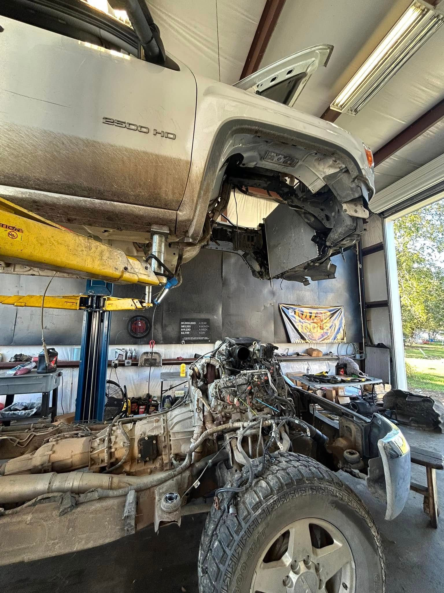 A truck is being worked on in a garage.