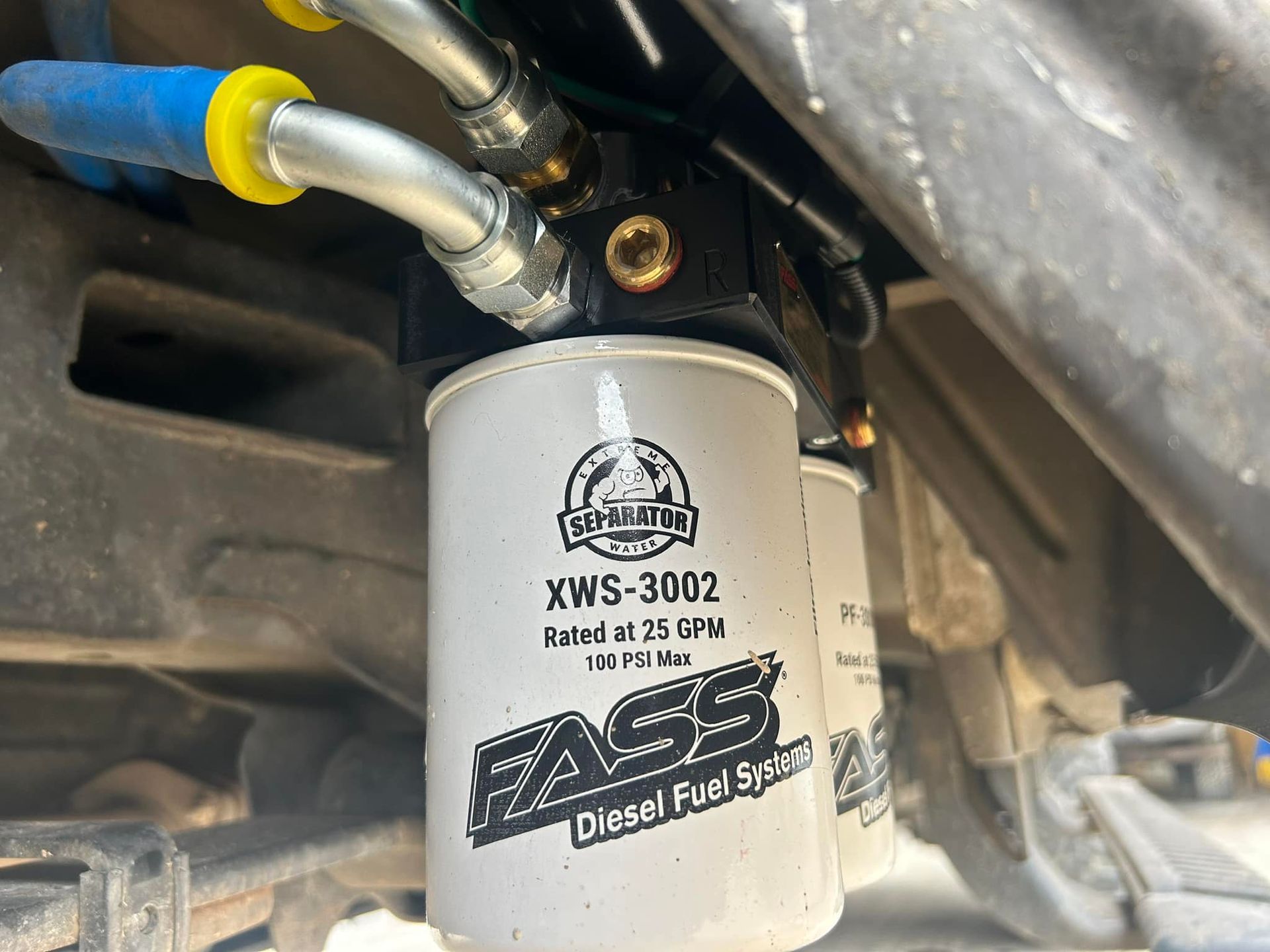 A close up of a fuel filter on a vehicle.