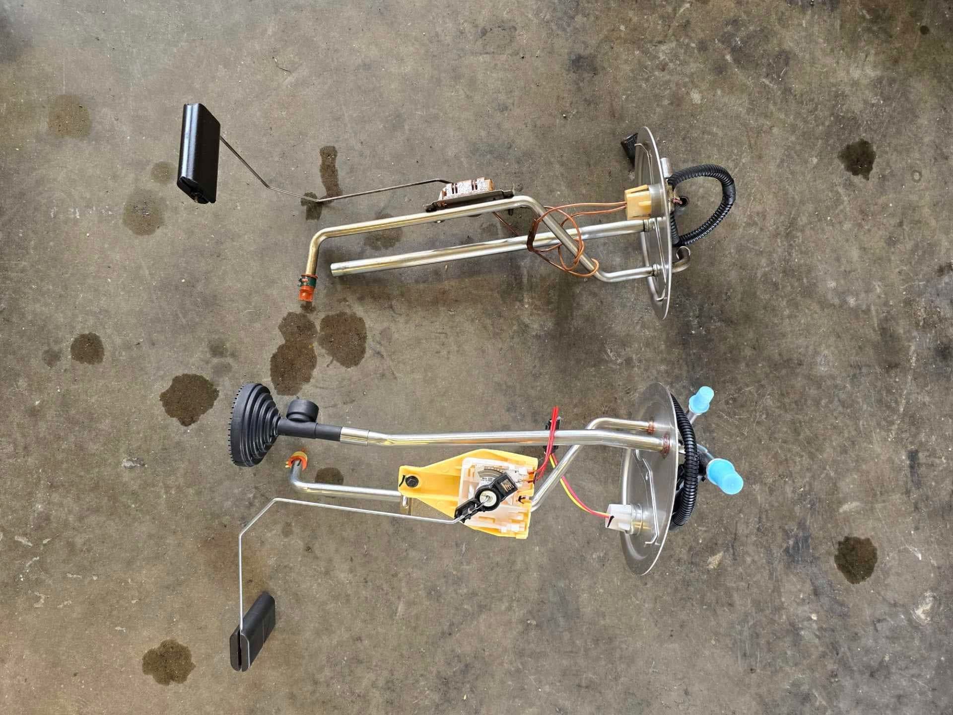 Two fuel gauges are sitting on a concrete surface.