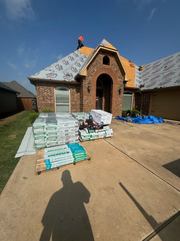 A man is working on the roof of a house.