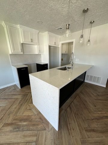 There is a large island in the middle of the kitchen.