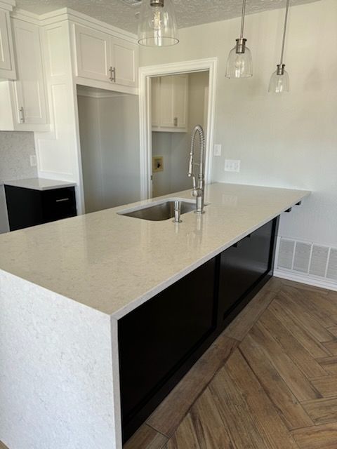 A kitchen with a large island and a sink