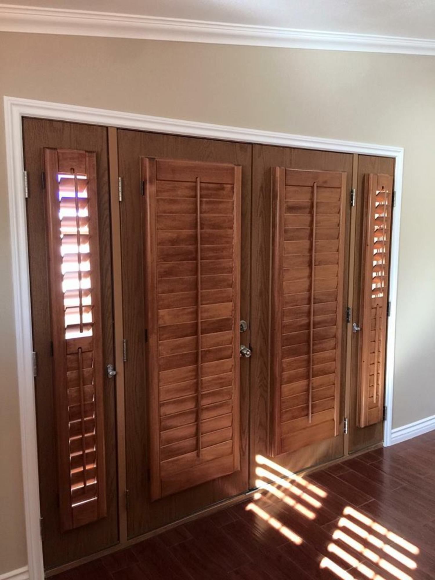 A room with wooden doors and shutters on them.