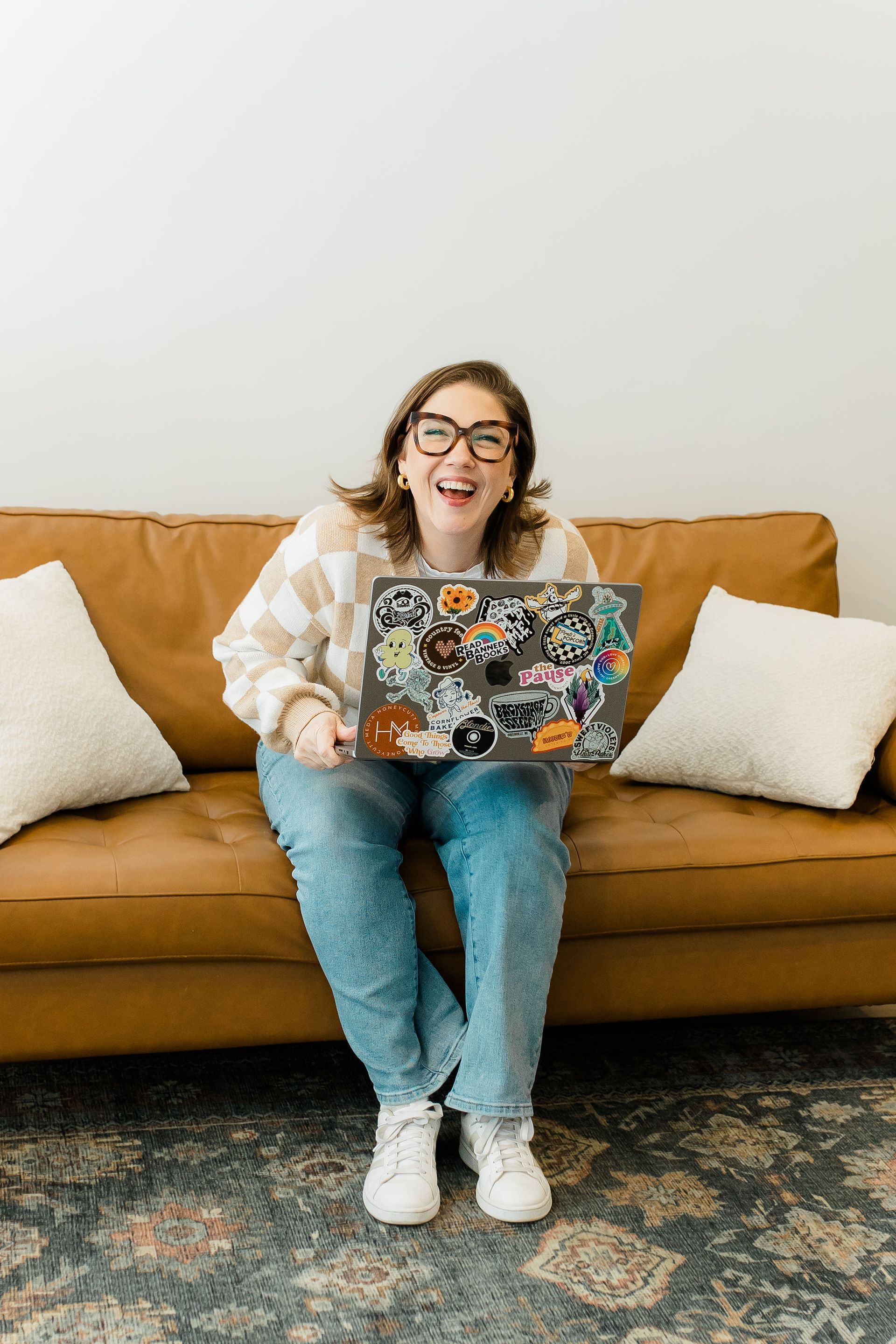 A woman is sitting in a chair with her arms in the air.