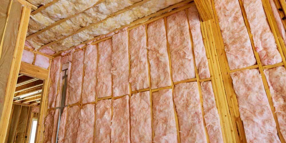 A house is being built with pink insulation on the walls.