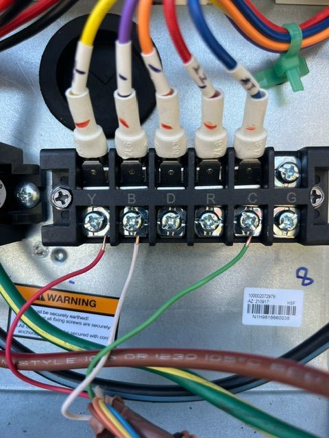 HVAC control board with colored wires labeled Y, B, O, R, C, G connected to a terminal block.