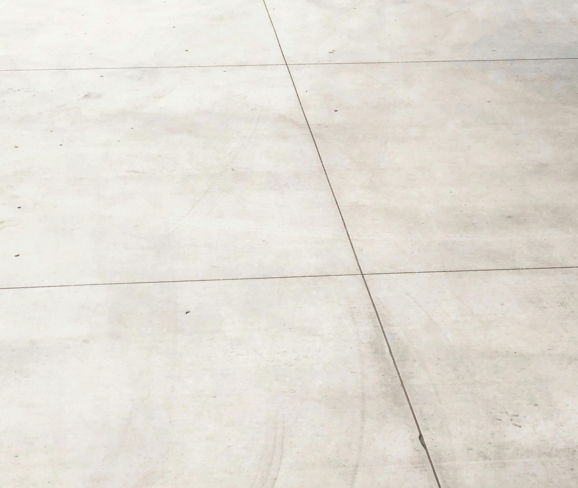 Gray concrete ground with crack lines.