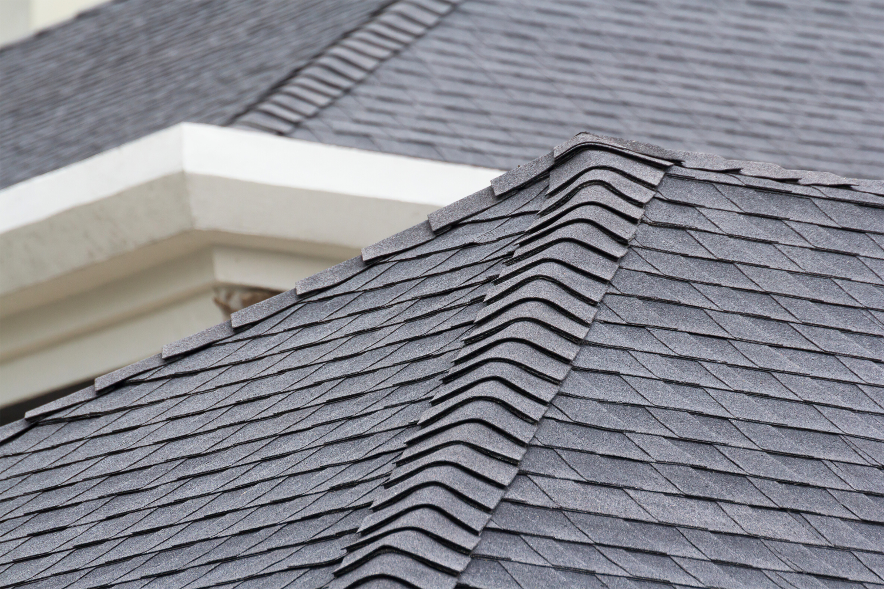 Corner of roof with grey shingles
