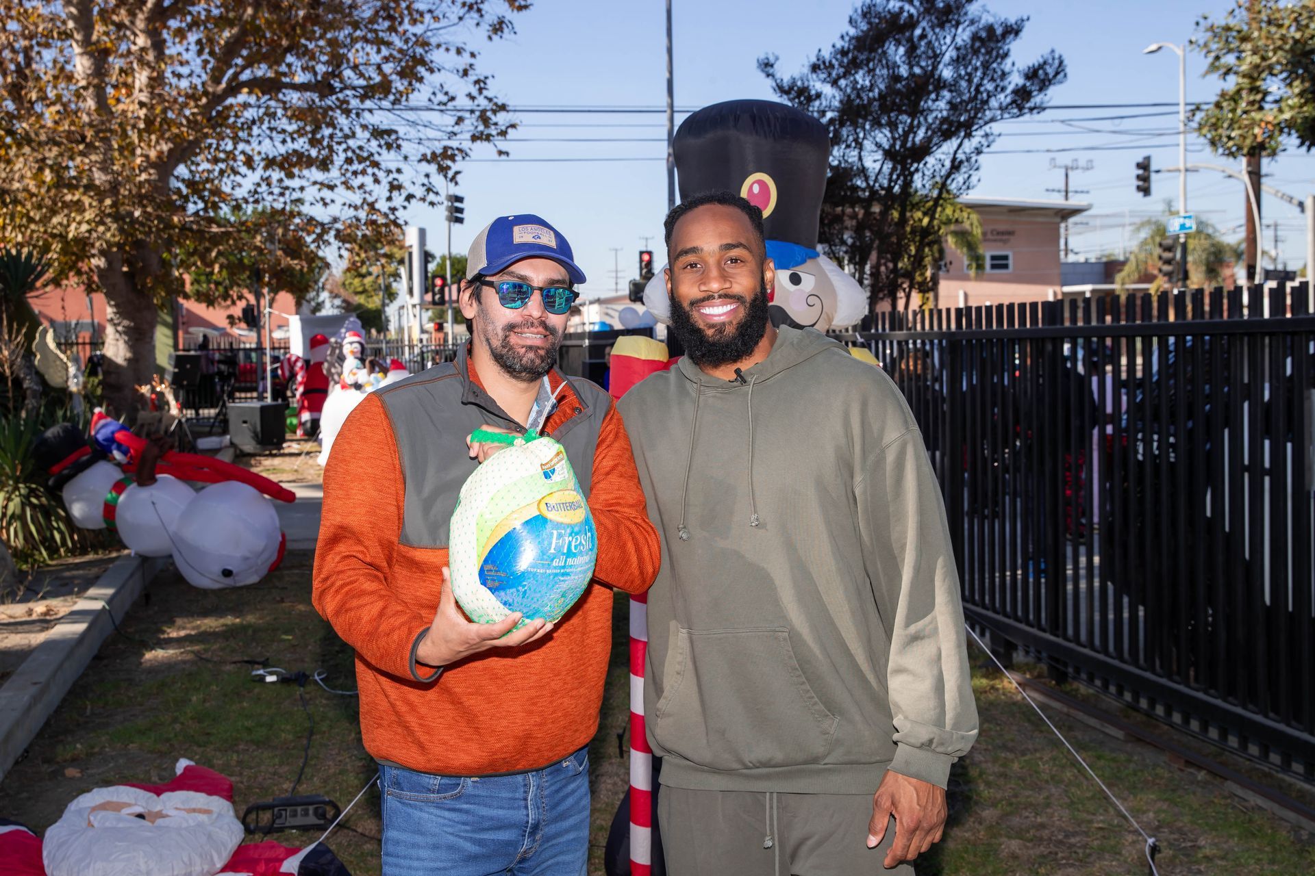 John Johnson III pose with a turkey and holiday decorations. 