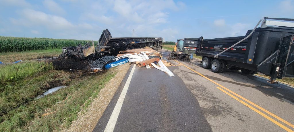 A truck has crashed into a field on the side of the road.