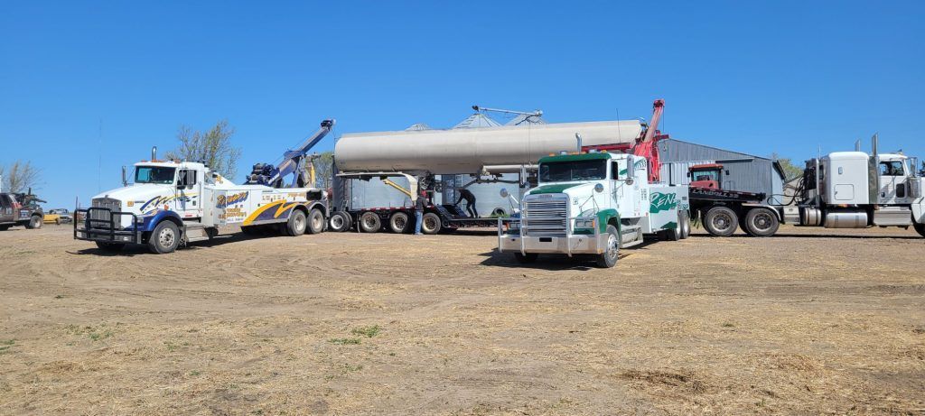 A group of trucks are parked in a field.
