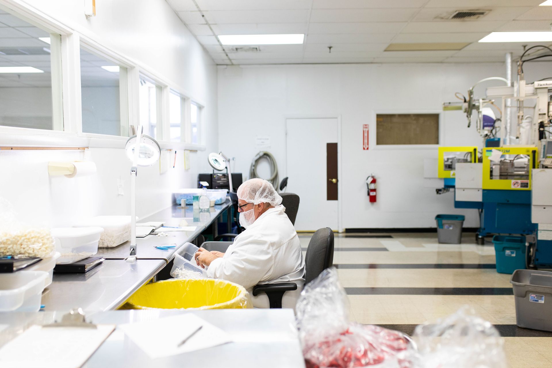 Man in lab coat working at desk in Cleanroom Plastic Injection Molding at Susquehanna Micro 