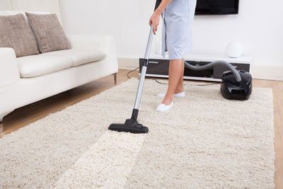 man cleaning carpet