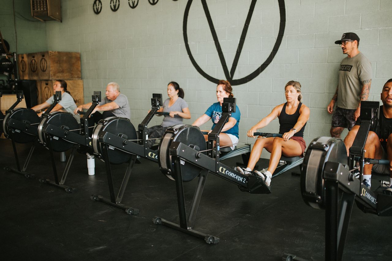 People on rowing machines at Verdant CrossFit North in Star, ID, with an instructor.