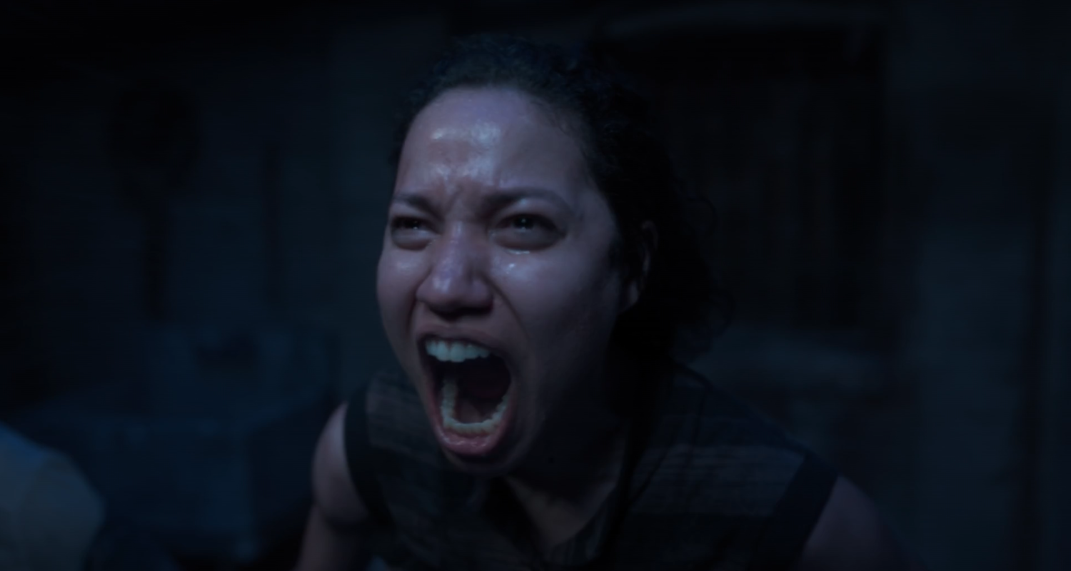 A black woman screaming and crying in a dimly lit basement. Leti Lewis, Lovecraft Country