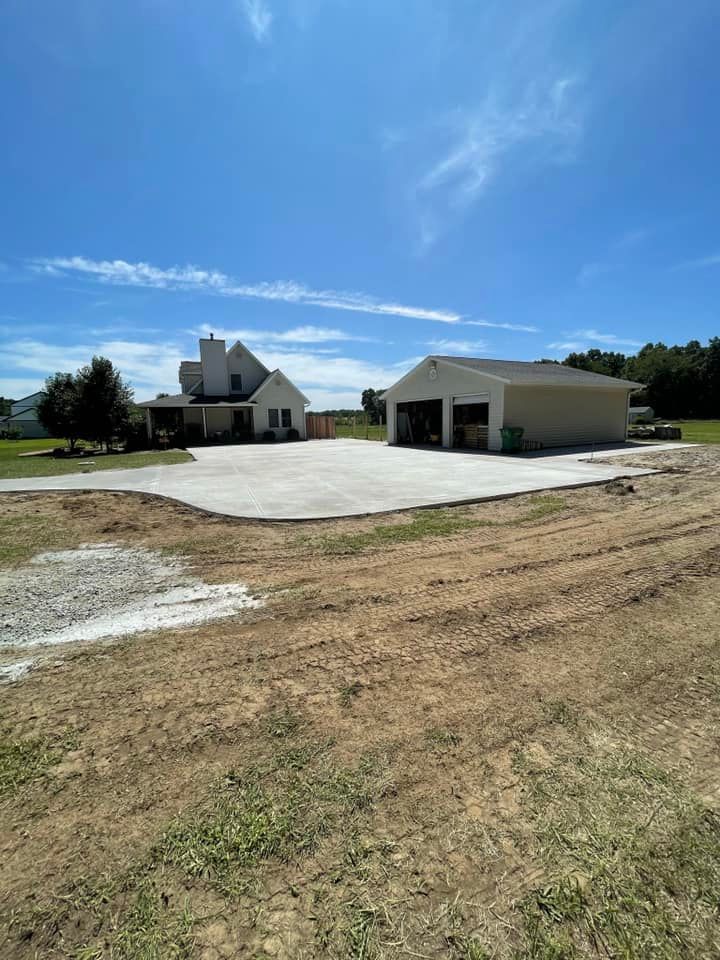 A large house with a garage and a concrete driveway in front of it.