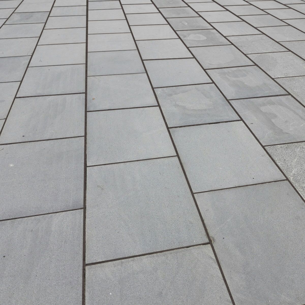A close up of a gray tiled floor