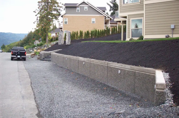 A white truck is parked on the side of a concrete driveway.