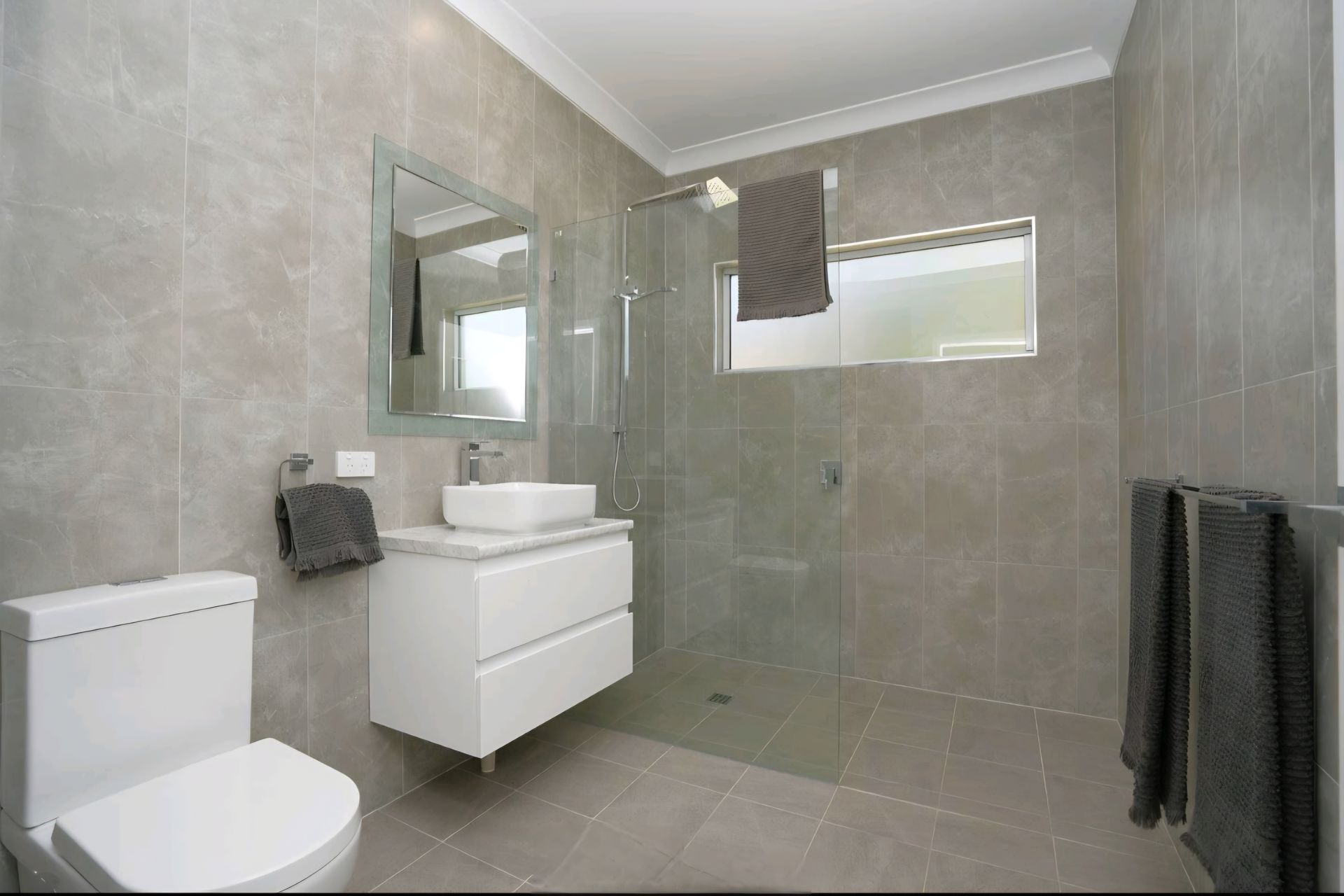Modern Bathroom With a Walk-in Shower, White Tub, Double Sinks, and a Window — CJ Custom Carpentry in Port Macquarie, NSW