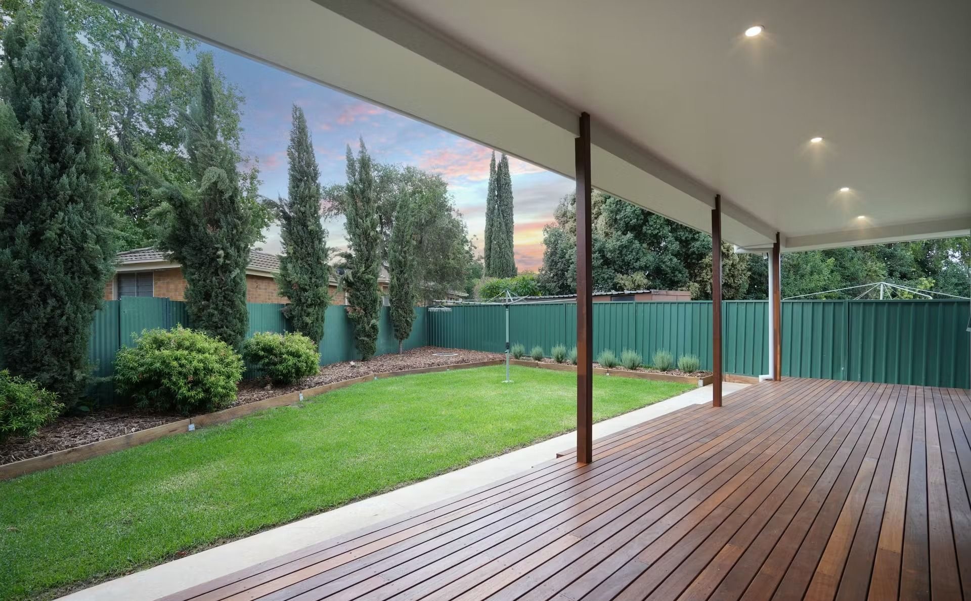 Patio With Pergola, Blue Seating, on Concrete, Surrounded by Landscaping — CJ Custom Carpentry in Port Macquarie, NSW