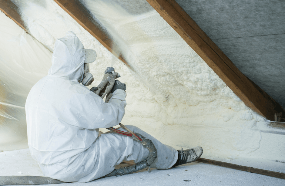 Picture of someone applying spray foam to an attic ceiling.