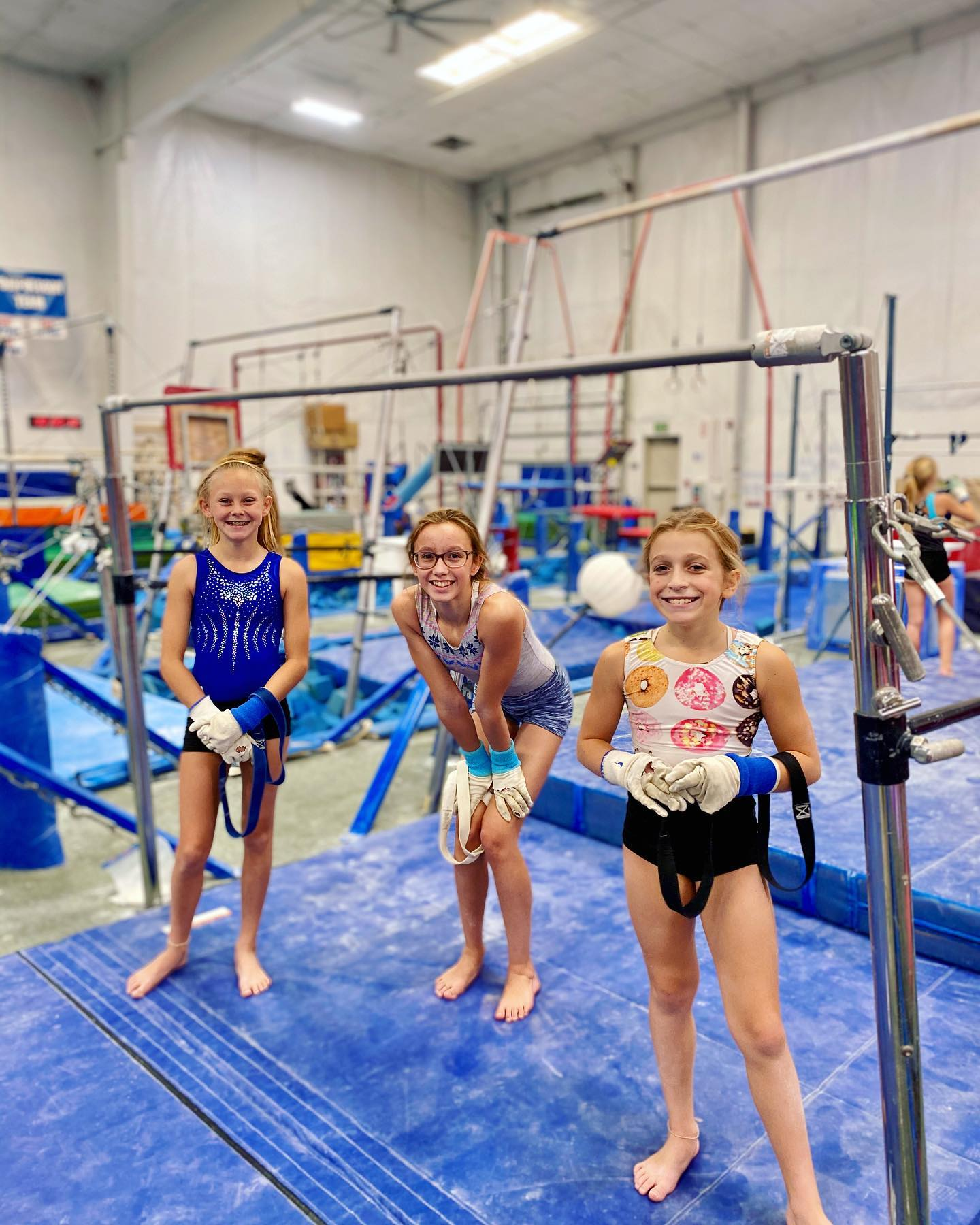 A group of cheerleaders are performing on a stage and one of them is wearing a shirt that says ' a '