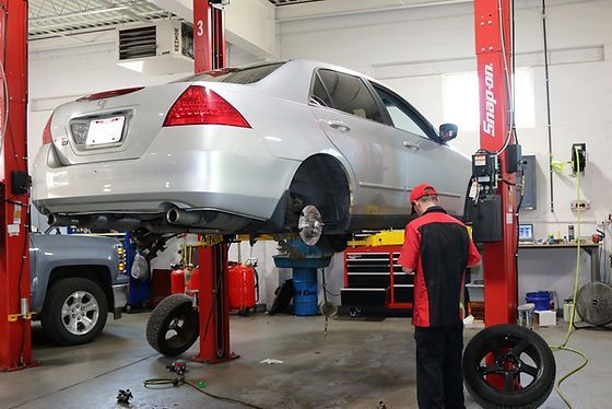Mechanics Performing Full Vehicle Inspection On Lift Inside Busy Repair Shop | Lake Erie Automotive Service