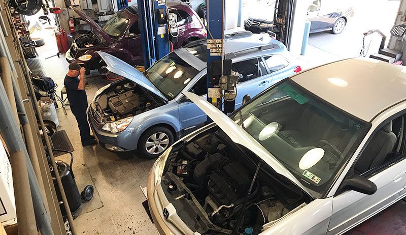 Multiple Vehicles Being Serviced Inside Busy Automotive Repair Facility | Lake Erie Automotive Service