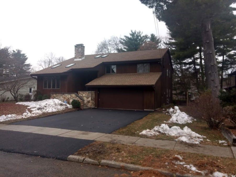 wood and stone house with a new roof