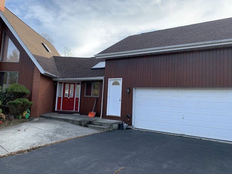 brown house with a new brown roof