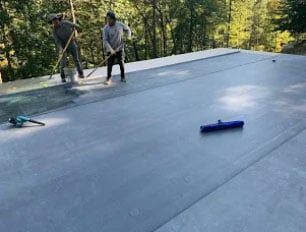 People installing new asphalt roof