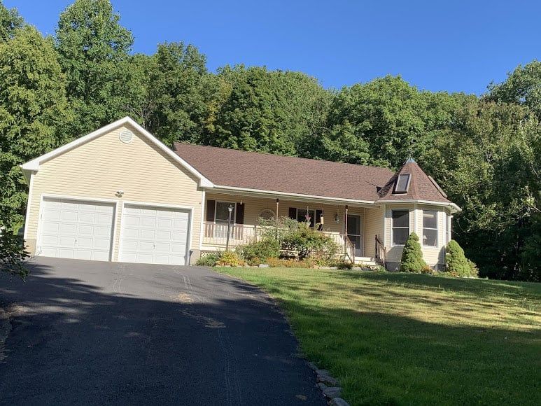 tan house with a new roof