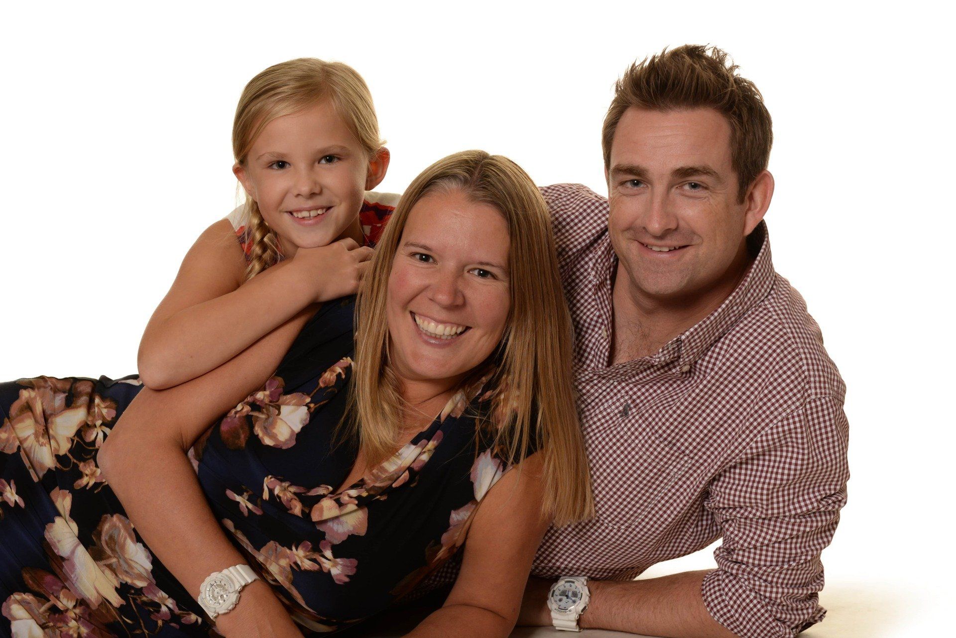 Various photographs including a family portrait, a child portrait, a child group photograph and branded school goods.