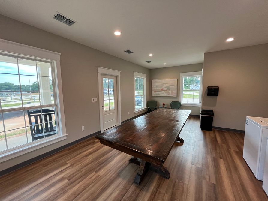 There is a large wooden table in the middle of the room.