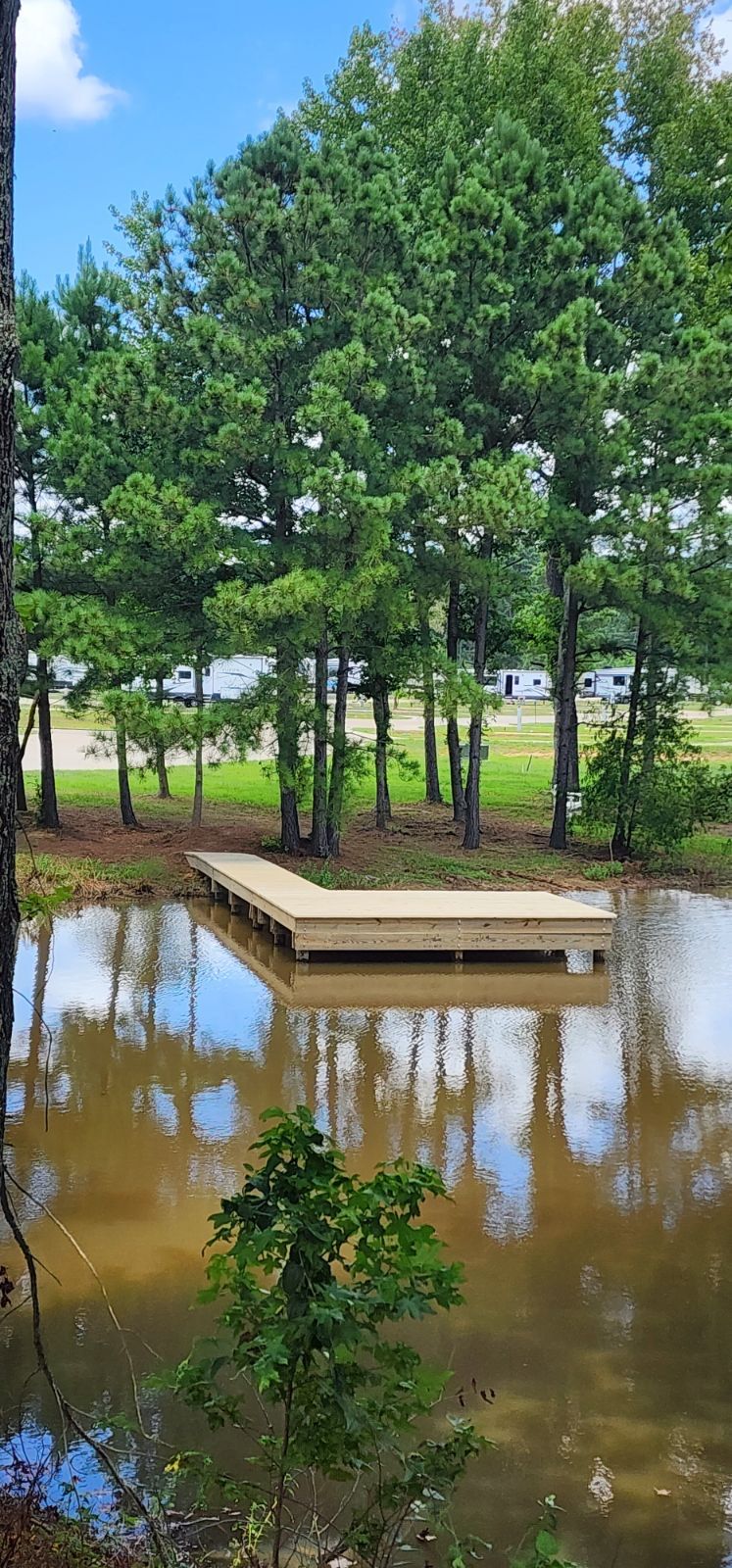 A large body of water surrounded by trees and grass.