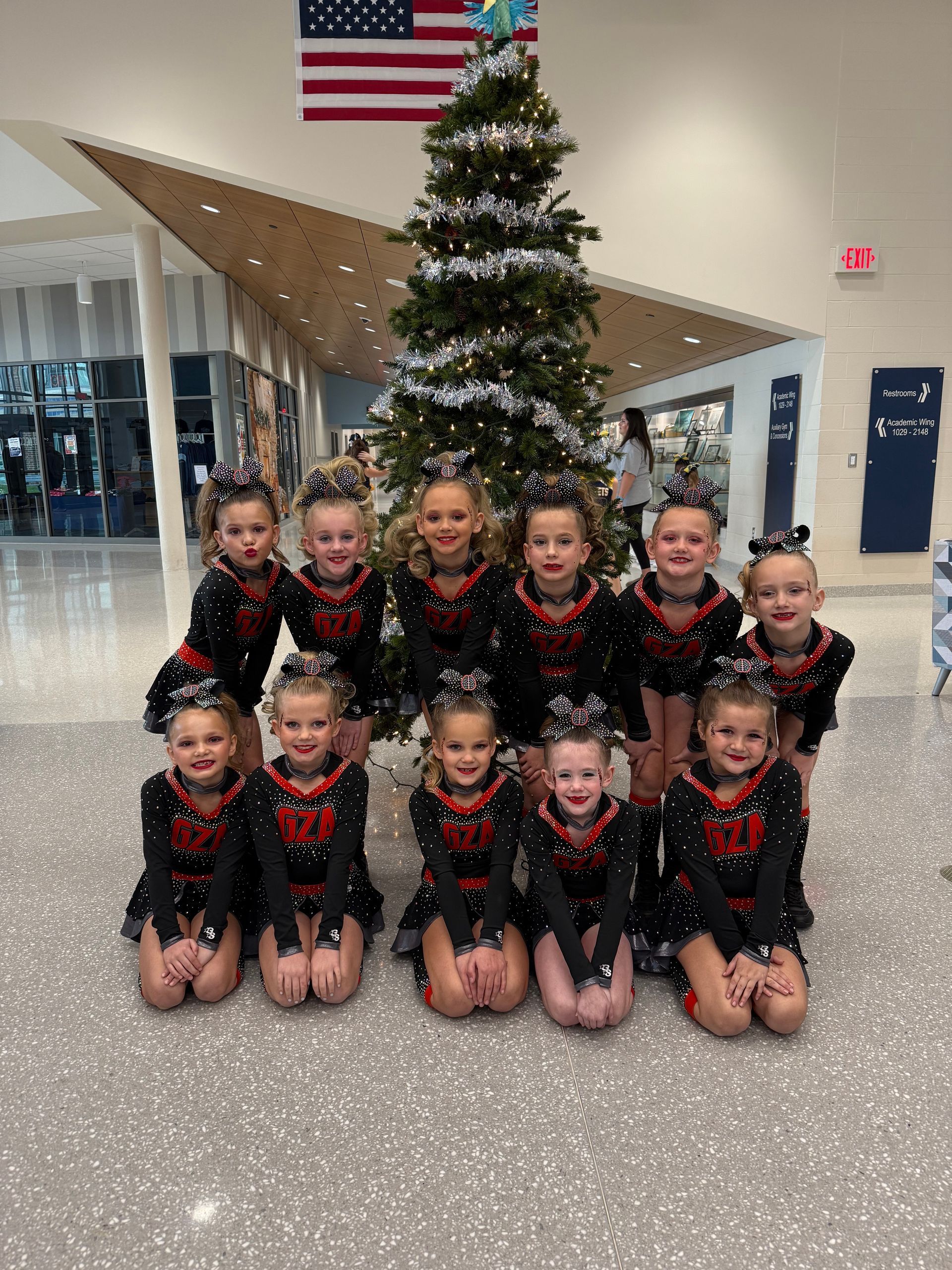 A cheerleader is being lifted in the air by another cheerleader