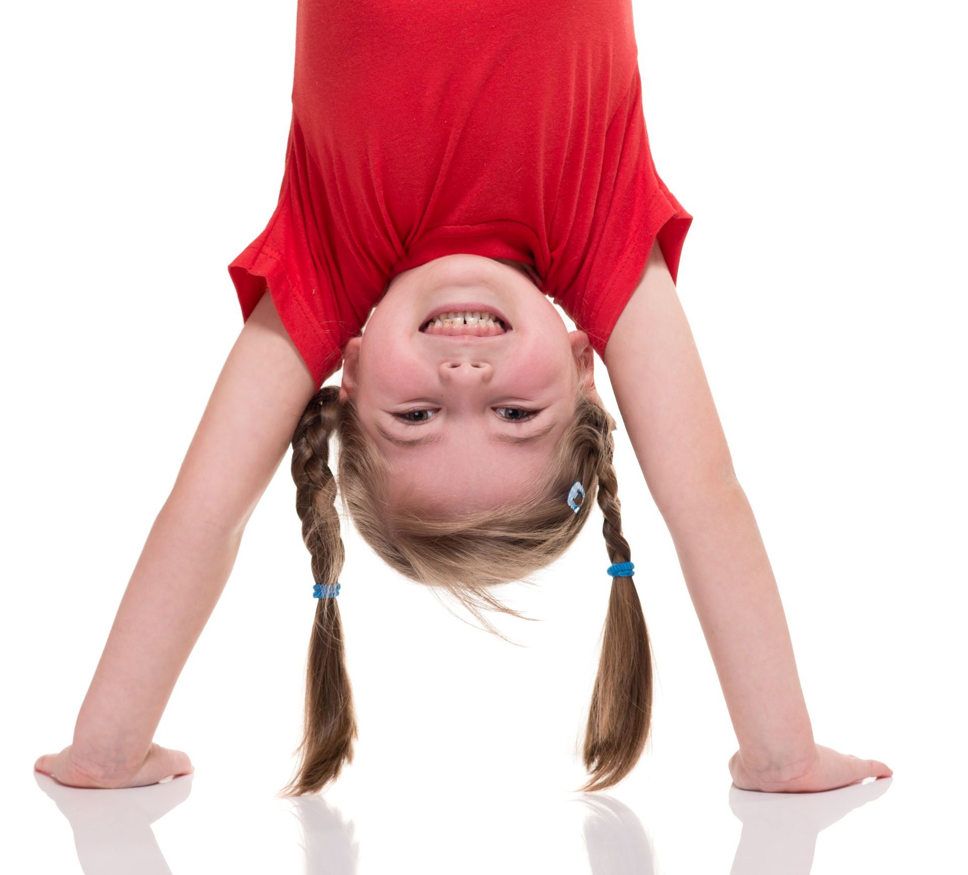 Girl performing gymnastics handstand smiling