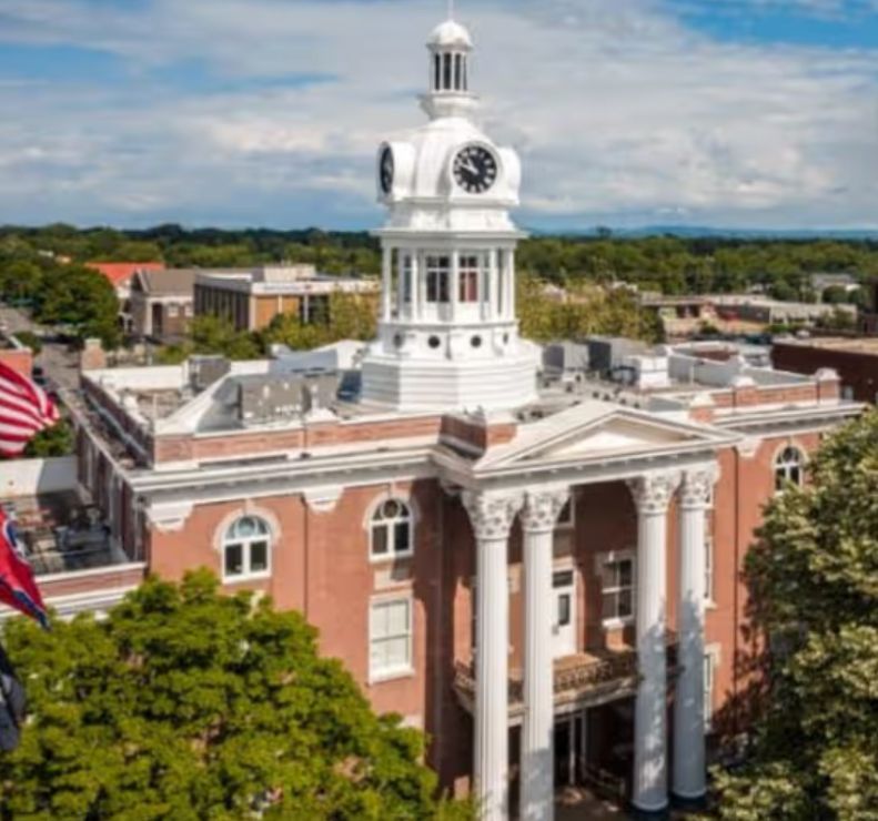 An aerial view of a courthouse with a clock tower