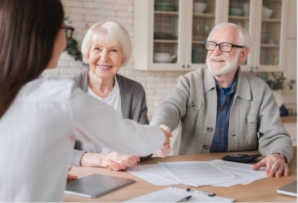 Couple shaking hands with their realtor