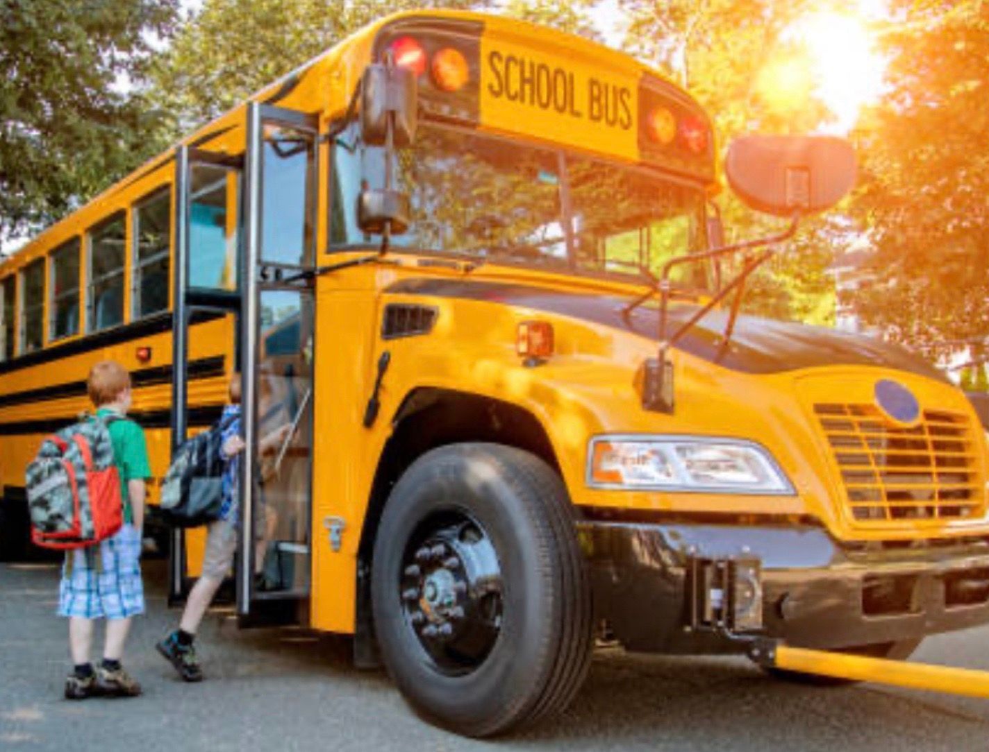 School children getting on a bus