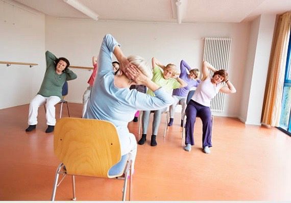 older people enjoying a stretching class