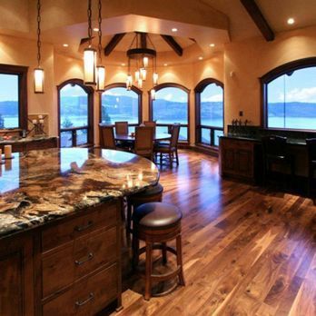 A kitchen with a large island and lots of windows