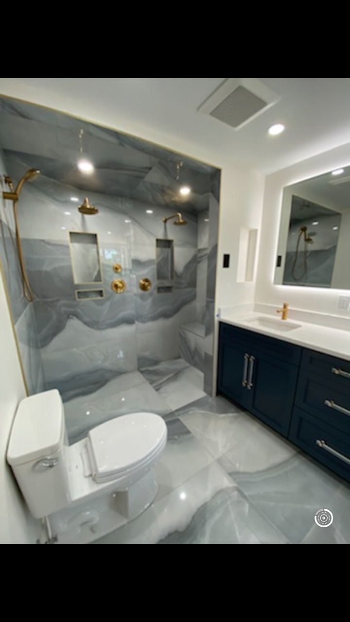 A bathroom with a toilet , sink , and shower.