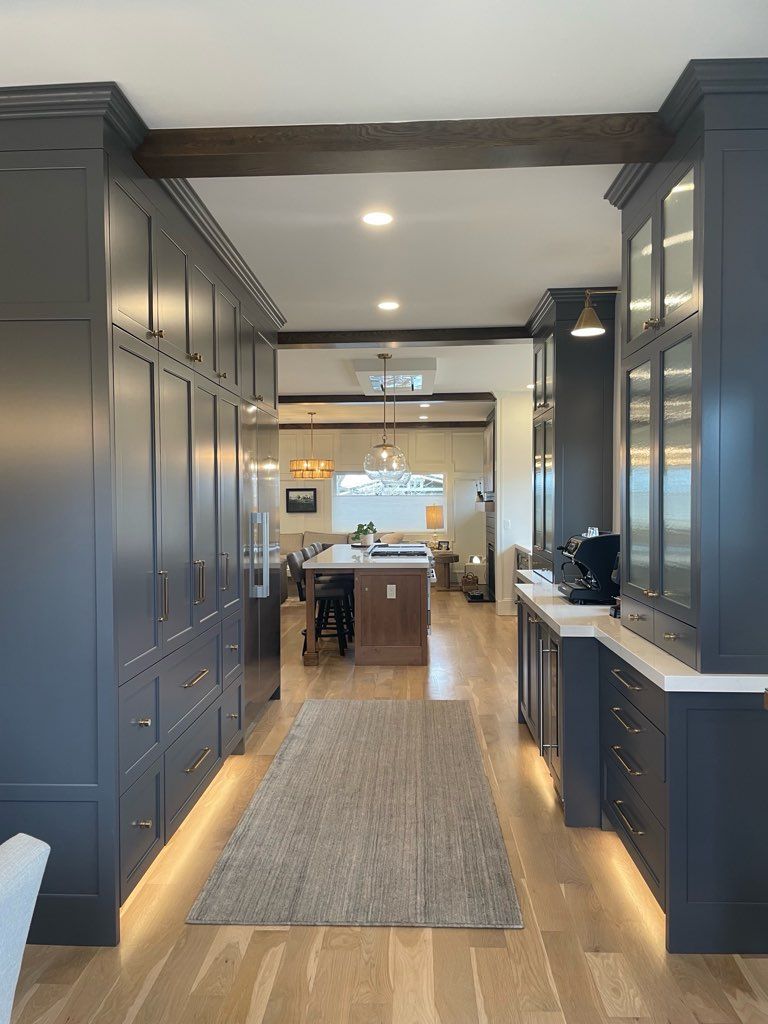 A kitchen with a long hallway leading to the kitchen
