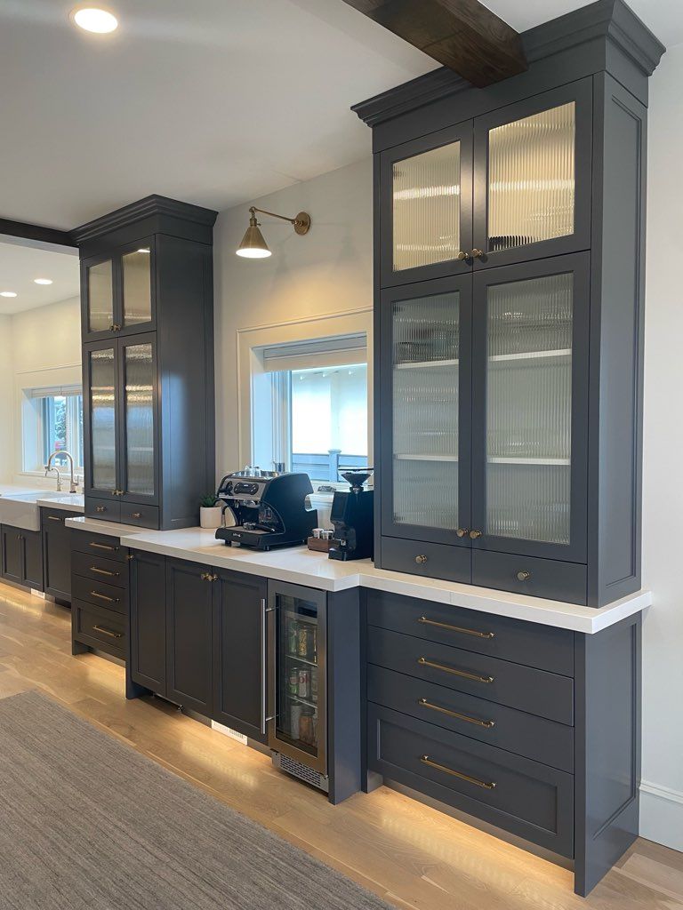 A kitchen with a lot of cabinets and a refrigerator.