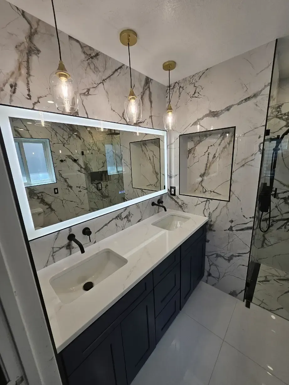 A bathroom with two sinks and a large mirror.