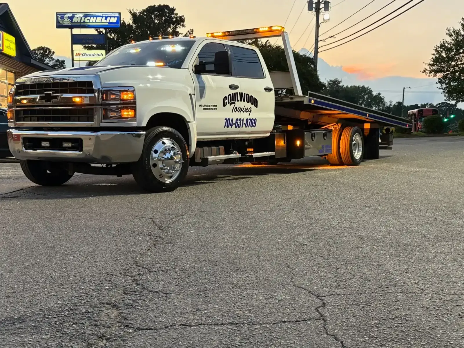White tow truck parked on asphalt.  