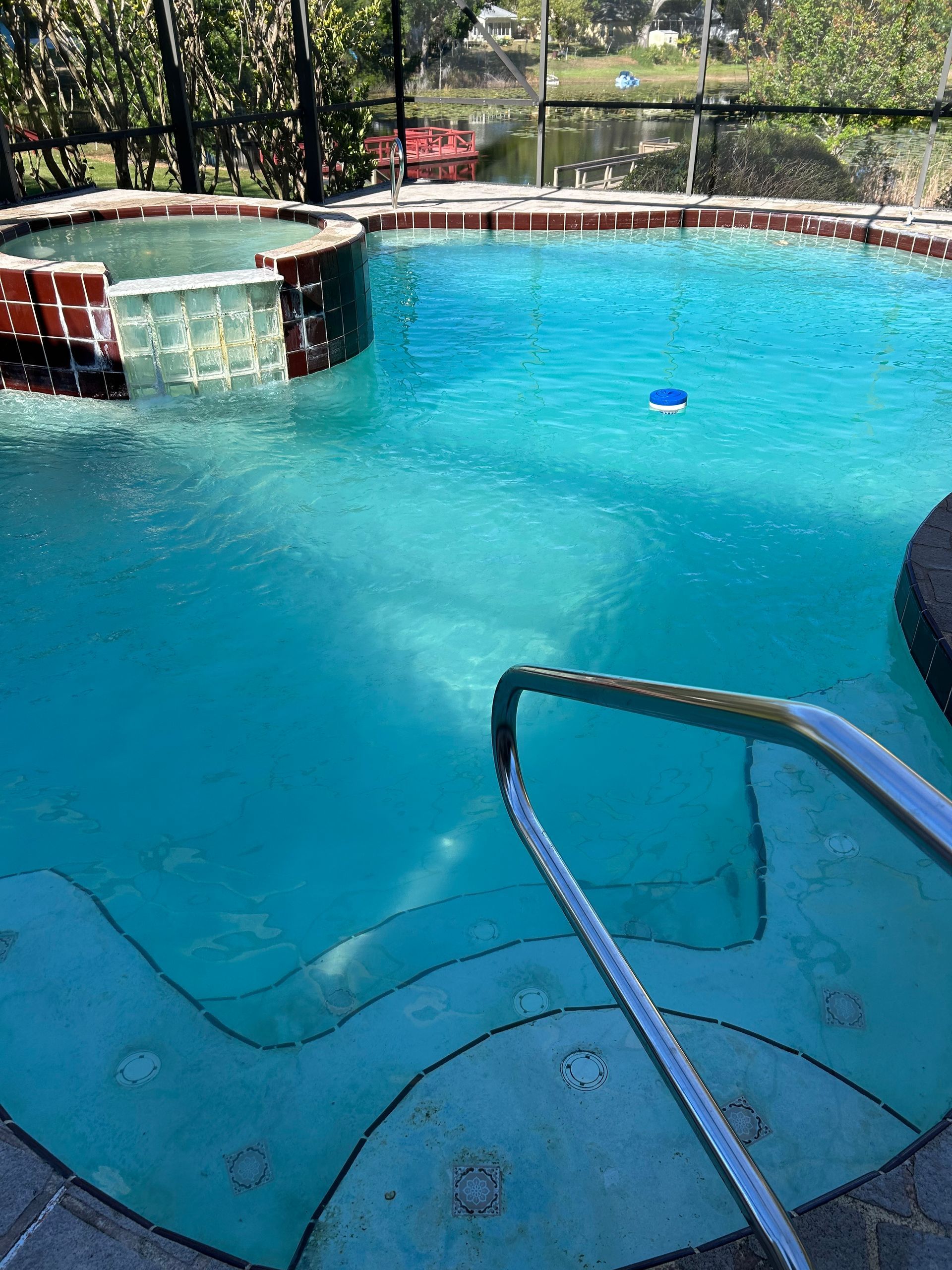 A large swimming pool with stairs leading to it