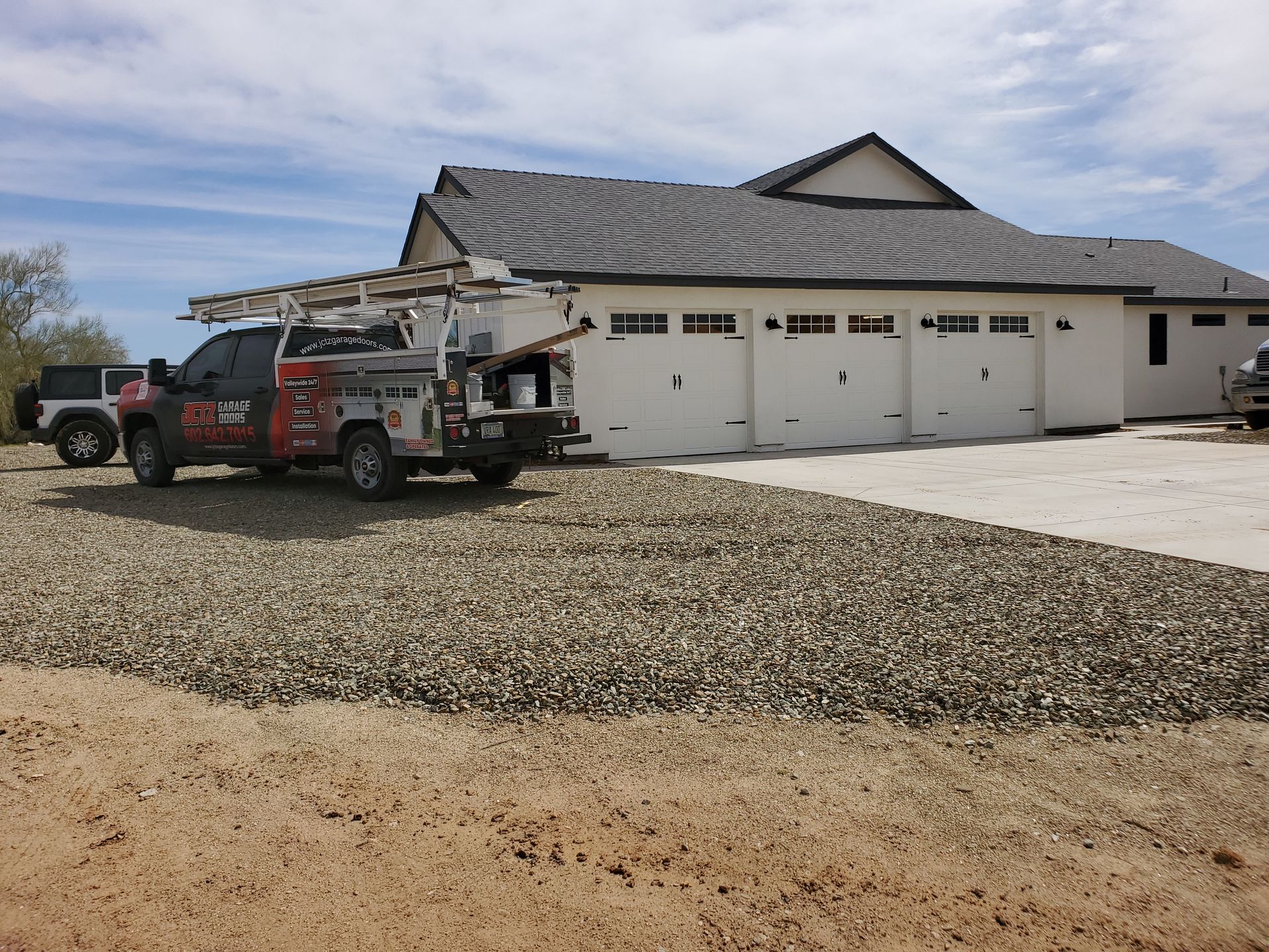 new home construction with three brand new garage doors