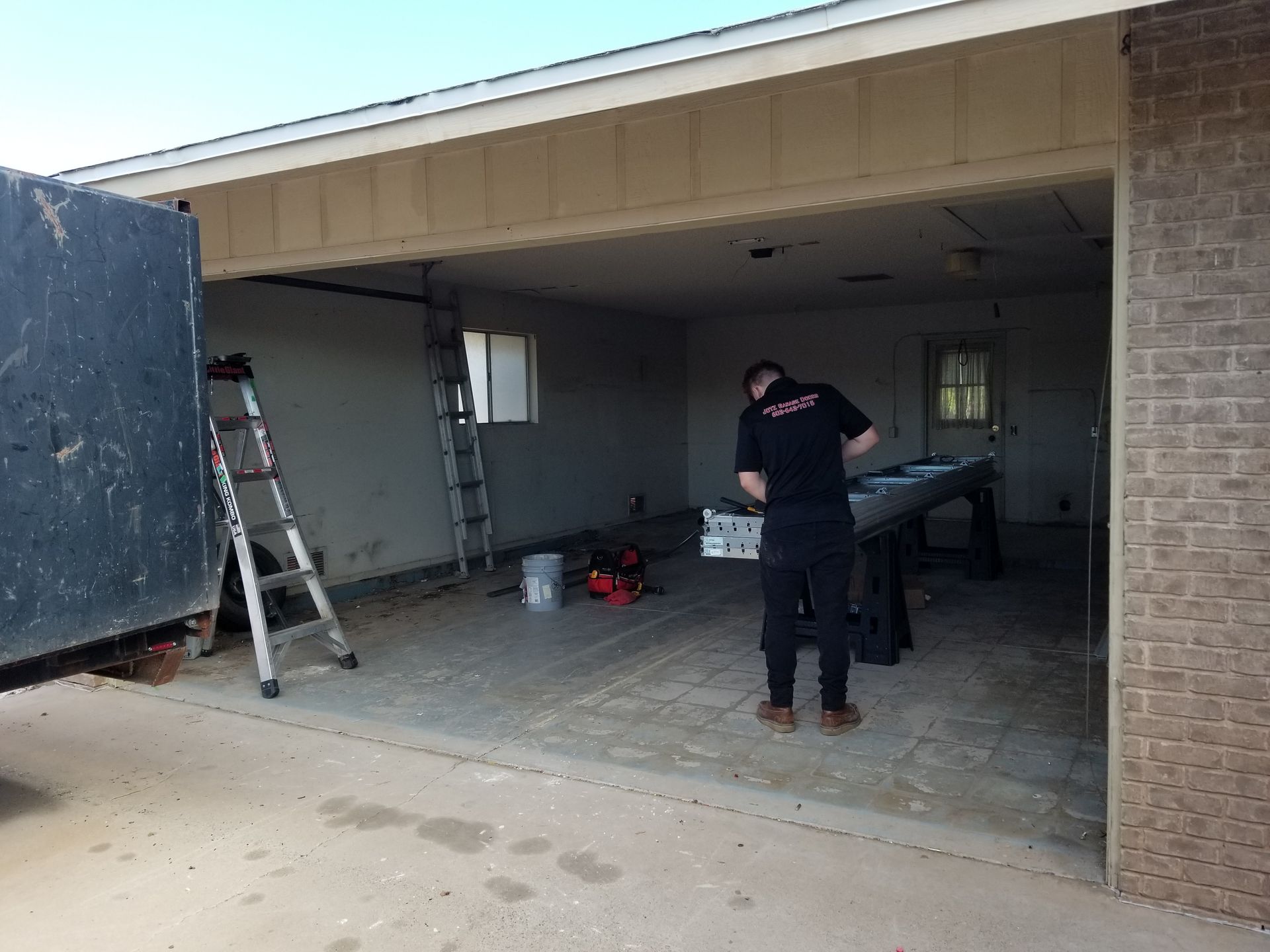 garage door tech prepping for new garage door installation